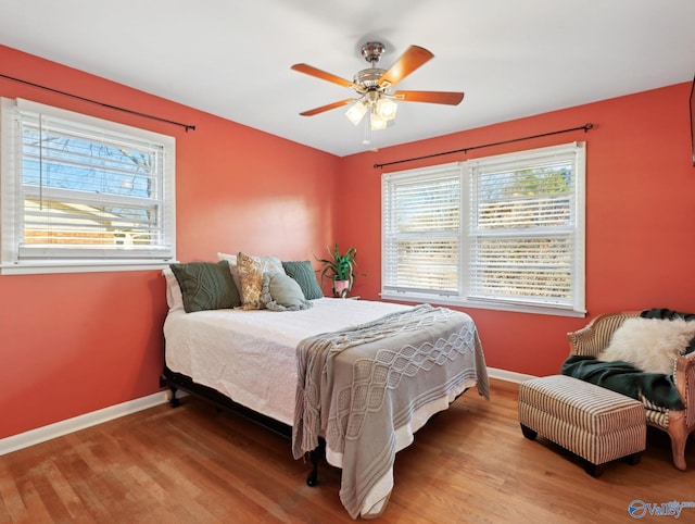 bedroom with ceiling fan and hardwood / wood-style flooring