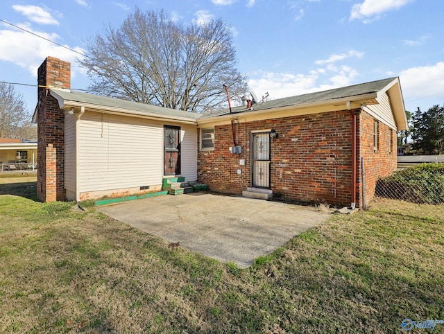 back of property featuring a lawn and a patio