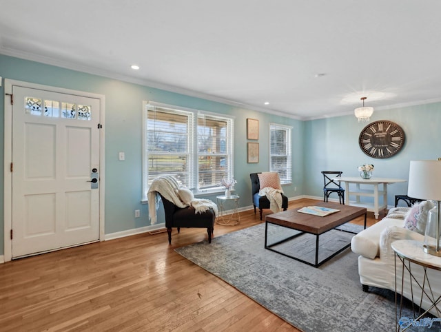 living room featuring ornamental molding, light hardwood / wood-style floors, and a notable chandelier