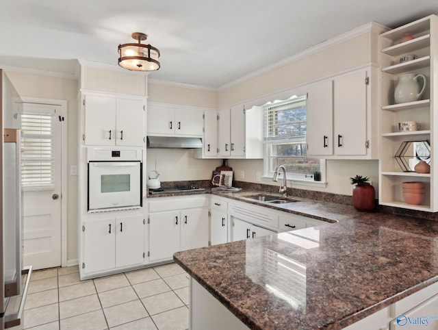 kitchen with oven, kitchen peninsula, sink, white cabinetry, and stainless steel gas cooktop