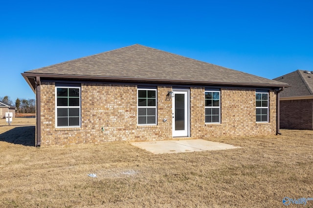 rear view of house featuring a patio area and a lawn