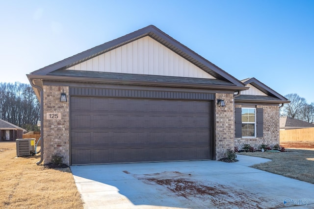 view of front of house featuring central air condition unit and a garage