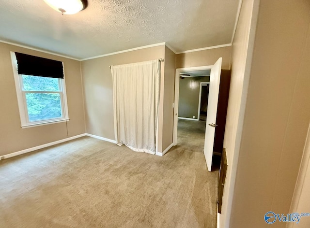 unfurnished bedroom featuring ornamental molding, carpet, and baseboards