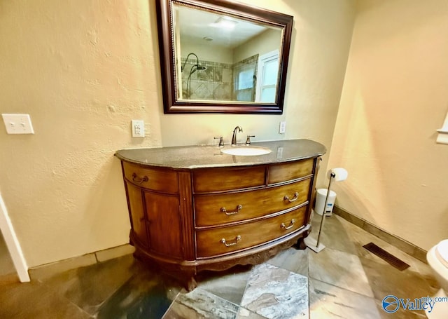 bathroom with baseboards, visible vents, toilet, and vanity