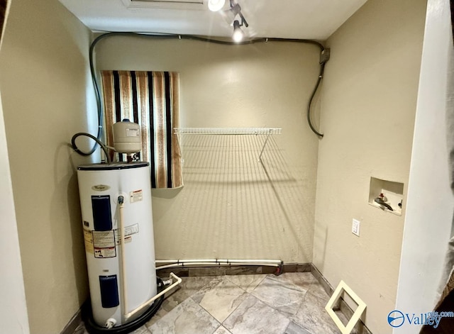 laundry room featuring washer hookup, visible vents, baseboards, water heater, and laundry area