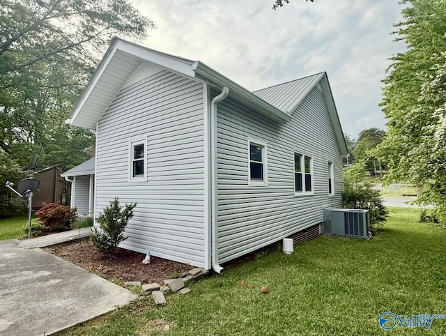 view of property exterior with a yard and central air condition unit