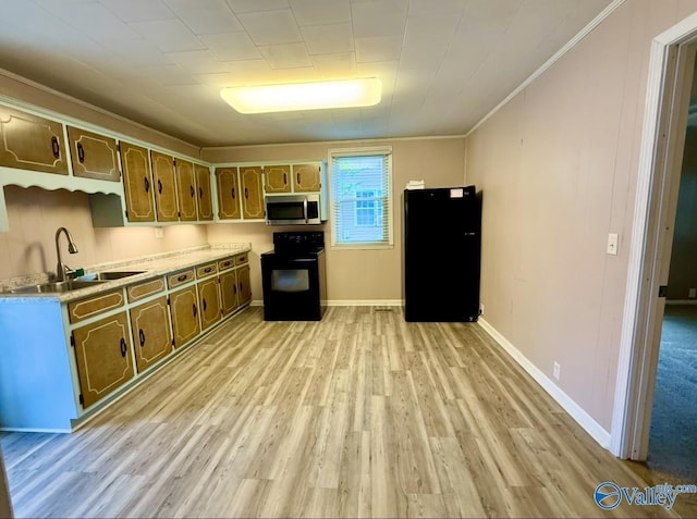 kitchen featuring a sink, light countertops, black appliances, ornamental molding, and light wood finished floors
