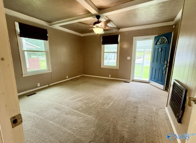 spare room with heating unit, coffered ceiling, beamed ceiling, ceiling fan, and carpet flooring