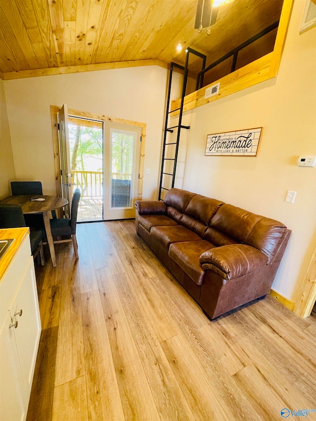 living room featuring lofted ceiling, wood ceiling, and light wood-type flooring