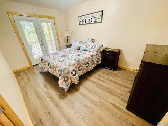 bedroom with french doors, access to outside, and light wood-type flooring