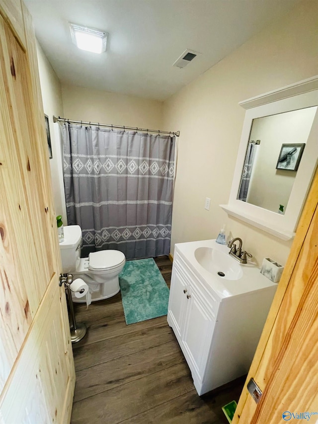 bathroom featuring vanity, a shower with curtain, wood-type flooring, and toilet