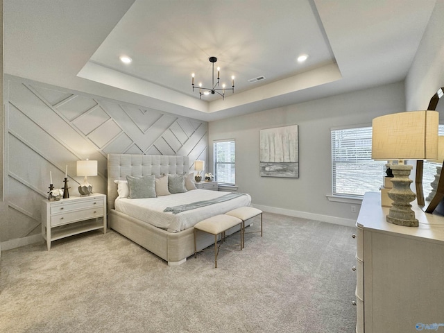 bedroom featuring a raised ceiling, a notable chandelier, light colored carpet, and baseboards