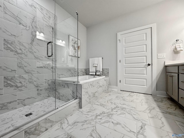 bathroom featuring vanity, baseboards, a stall shower, a bath, and marble finish floor