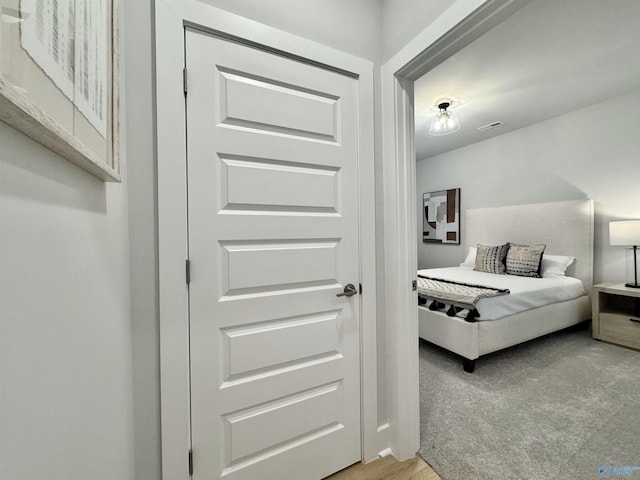 bedroom with visible vents and light carpet