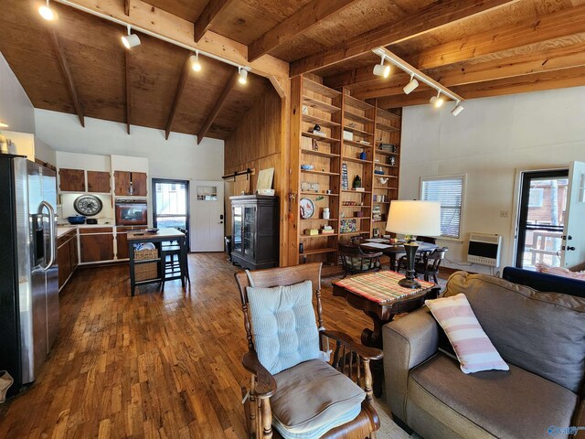 living room with track lighting, wood ceiling, heating unit, beam ceiling, and dark hardwood / wood-style floors