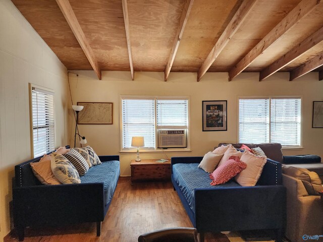 living room featuring hardwood / wood-style flooring, cooling unit, and beamed ceiling