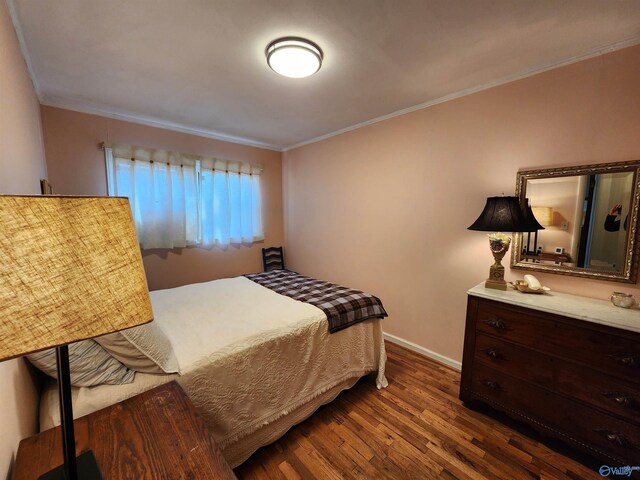 bedroom featuring dark hardwood / wood-style flooring and crown molding