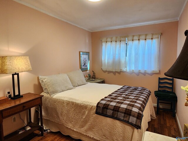 bedroom with dark wood-type flooring and ornamental molding