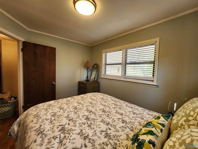 bedroom featuring hardwood / wood-style flooring and crown molding