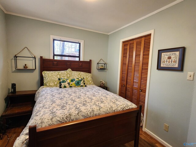 bedroom with dark hardwood / wood-style flooring, ornamental molding, and a closet