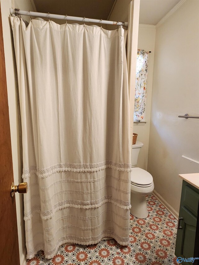 bathroom featuring vanity, ornamental molding, and toilet