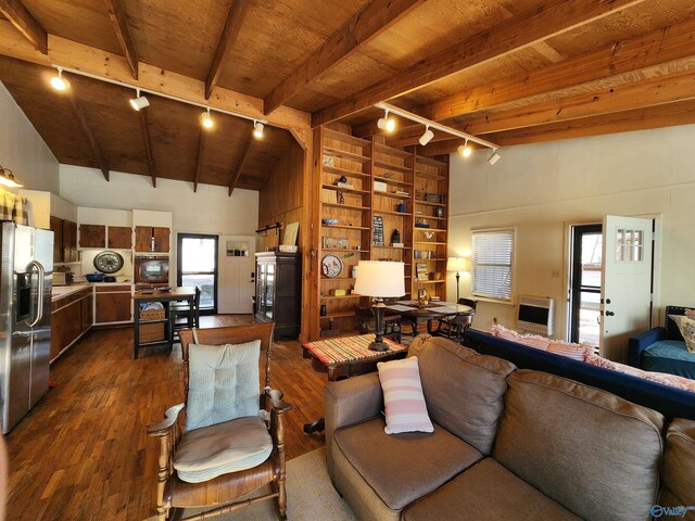 living room with wooden ceiling, lofted ceiling with beams, rail lighting, built in shelves, and dark hardwood / wood-style flooring