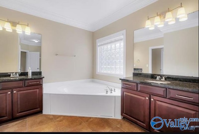 bathroom featuring tile patterned flooring, a washtub, crown molding, and vanity