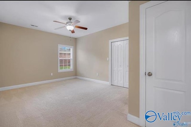 unfurnished room featuring ceiling fan and light colored carpet