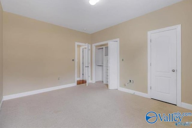 unfurnished bedroom featuring light carpet