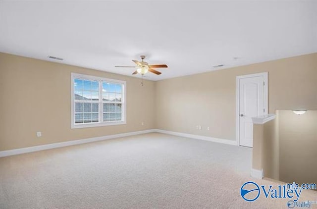 unfurnished room with ceiling fan and light colored carpet