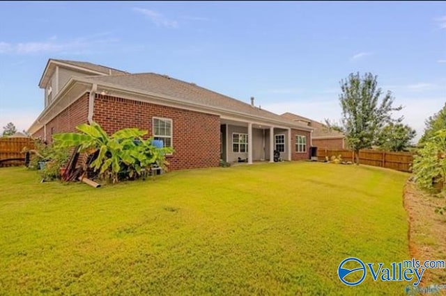 rear view of house with a lawn