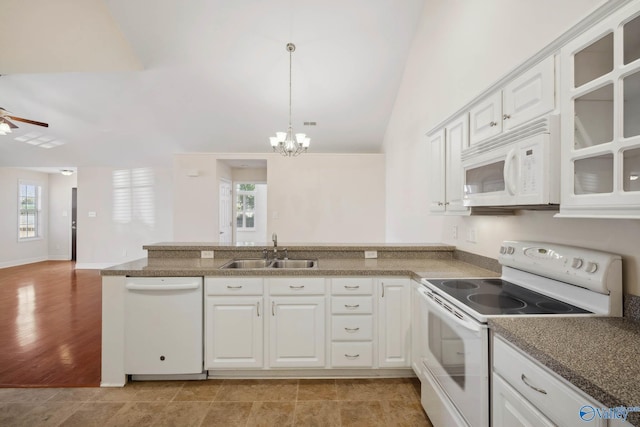 kitchen with ceiling fan with notable chandelier, a peninsula, white appliances, a sink, and glass insert cabinets