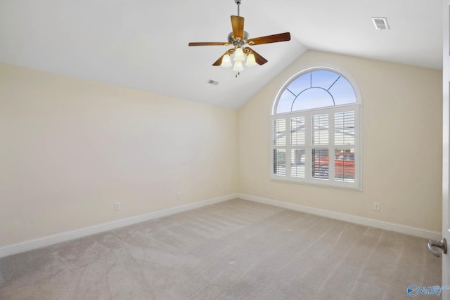 unfurnished room with carpet floors, lofted ceiling, and baseboards