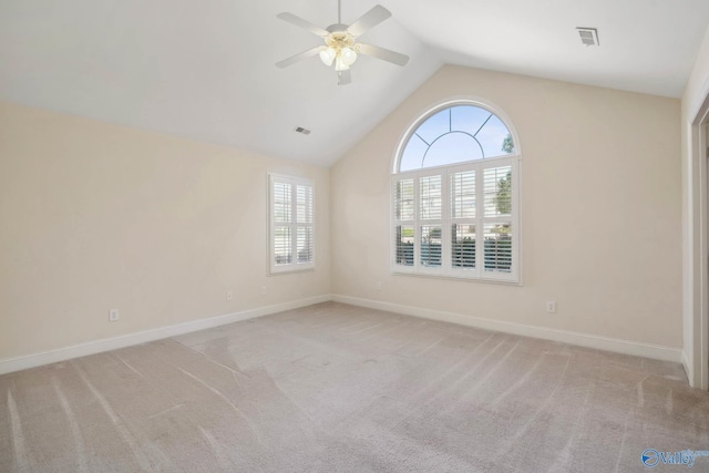 unfurnished room with baseboards, visible vents, a ceiling fan, lofted ceiling, and carpet floors