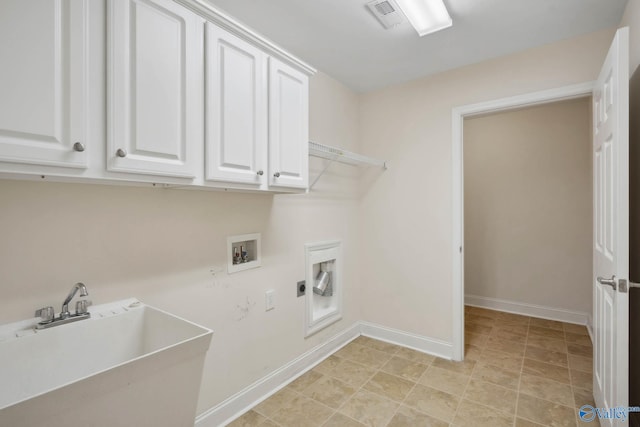 laundry room featuring cabinet space, baseboards, a sink, hookup for a washing machine, and electric dryer hookup