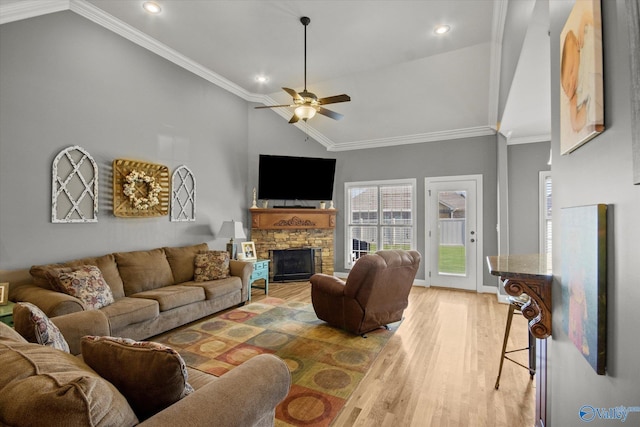 22915 Pin Oak Dr, Athens, AL 35613 - living room featuring light wood-style flooring, vaulted ceiling, crown molding, and a stone fireplace