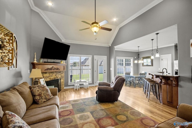22915 Pin Oak Dr, Athens, AL 35613 - living area featuring lofted ceiling, light wood-type flooring, a fireplace, and crown molding