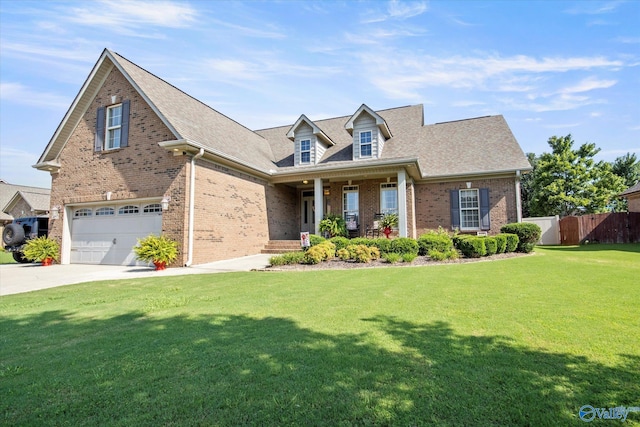 cape cod house featuring covered porch and a front yard