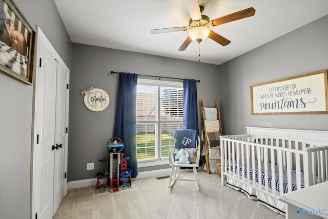 22915 Pin Oak Dr, Athens, AL 35613 - carpeted bedroom featuring a closet, ceiling fan, a crib, and baseboards