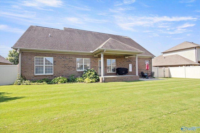 22915 Pin Oak Dr, Athens, AL 35613 - back of house with brick siding, a lawn, a patio area, and a fenced backyard