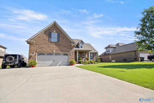 22915 Pin Oak Dr, Athens, AL 35613 - traditional-style home with a front yard, concrete driveway, brick siding, and an attached garage