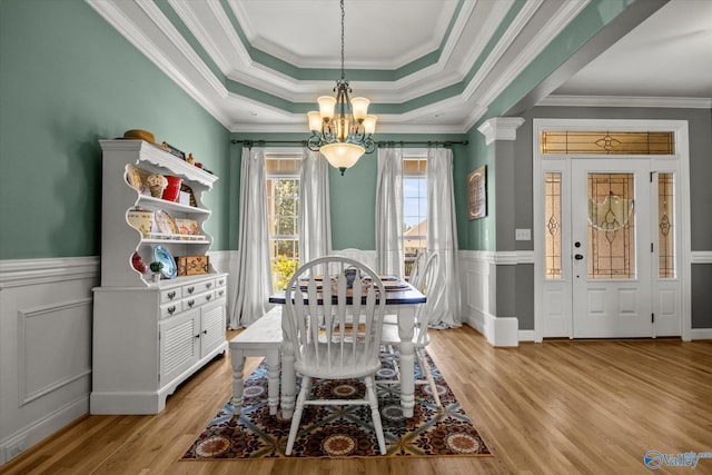 22915 Pin Oak Dr, Athens, AL 35613 - dining area with a tray ceiling, wainscoting, light wood-style flooring, and a notable chandelier