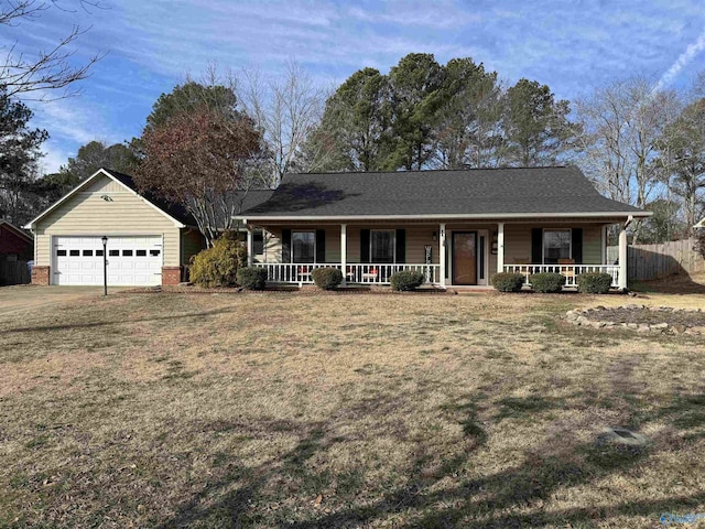 ranch-style house with covered porch, a front yard, and a garage