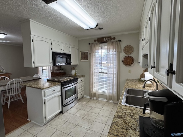 kitchen featuring sink, white cabinets, stainless steel range oven, light tile patterned flooring, and ornamental molding