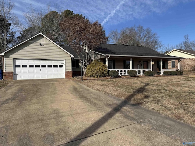 single story home featuring covered porch, a garage, and a front lawn