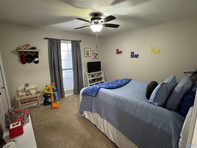 bedroom with ceiling fan, carpet, and a textured ceiling