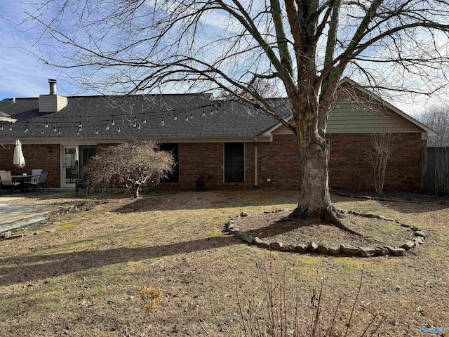 back of house with a patio area and a yard