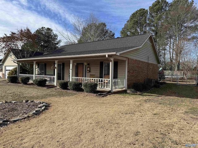 view of front of home with covered porch and a front yard