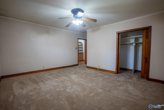 unfurnished bedroom featuring crown molding, carpet, baseboards, and a closet