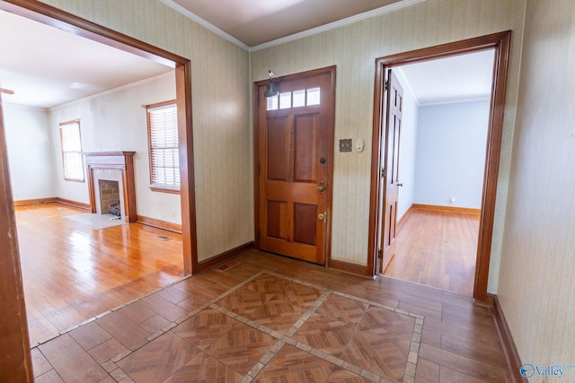 foyer featuring parquet flooring, crown molding, and wallpapered walls